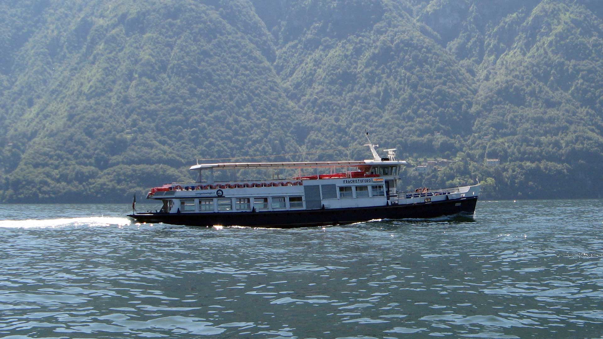 Historic passenger ferry cruising across Lake Como.