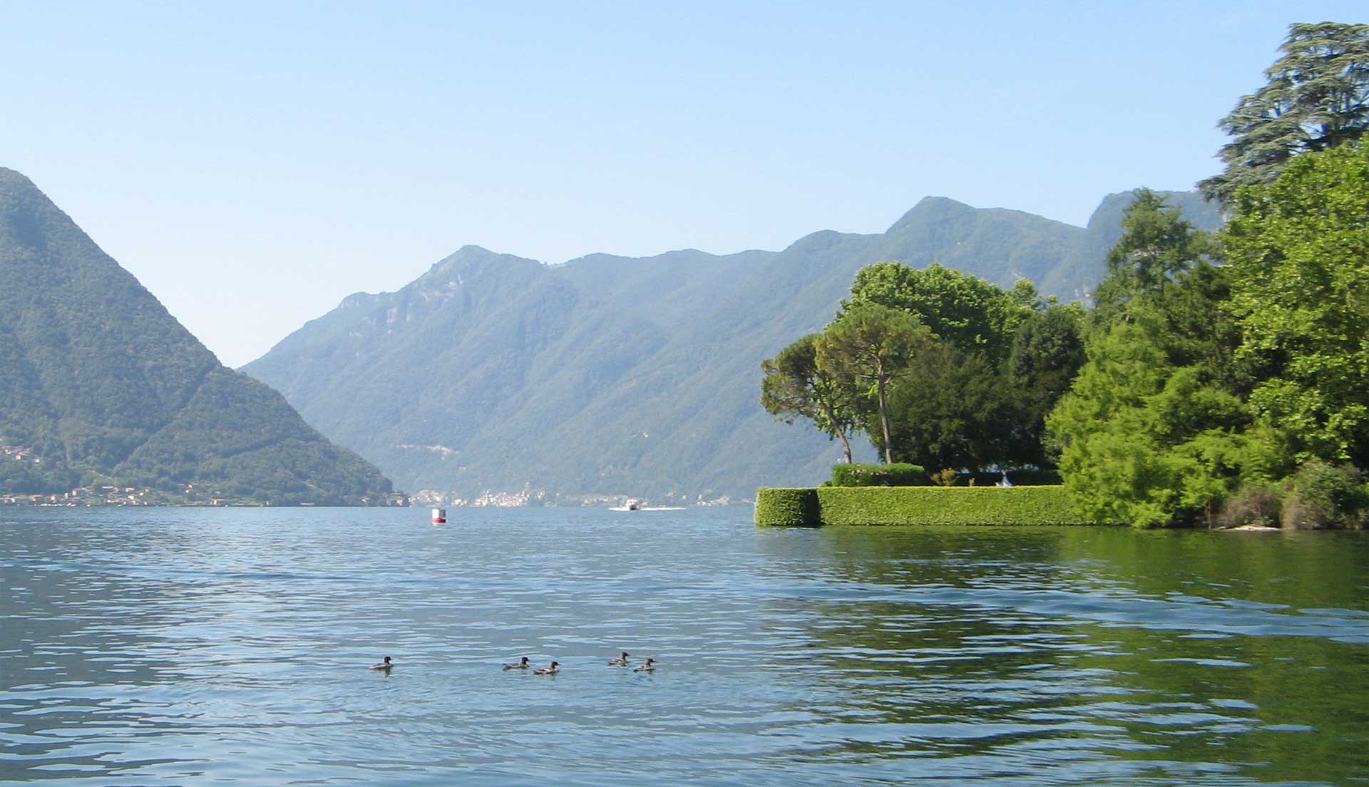 Wide panorama of Lake Como during a self-drive boating experience.